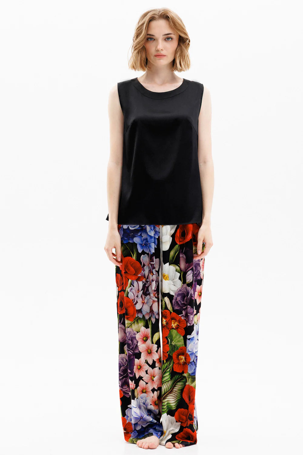 Woman wearing a black silk sleeveless top and colorful silk pants (sold separately) showing the front full look