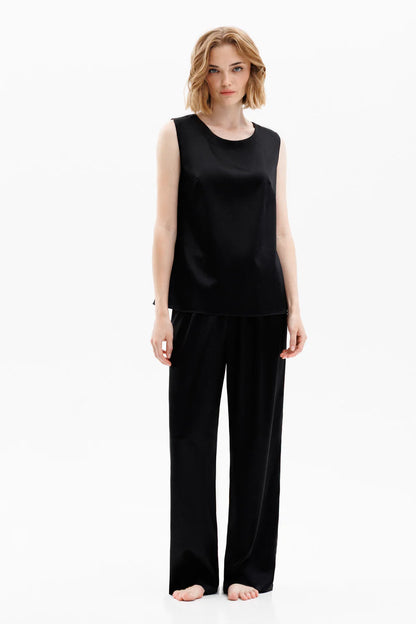 Woman wearing a black silk sleeveless top (sold separately) and black silk pants 