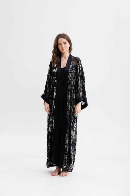 Woman wearing a black floral silk velvet kimono. Front full picture